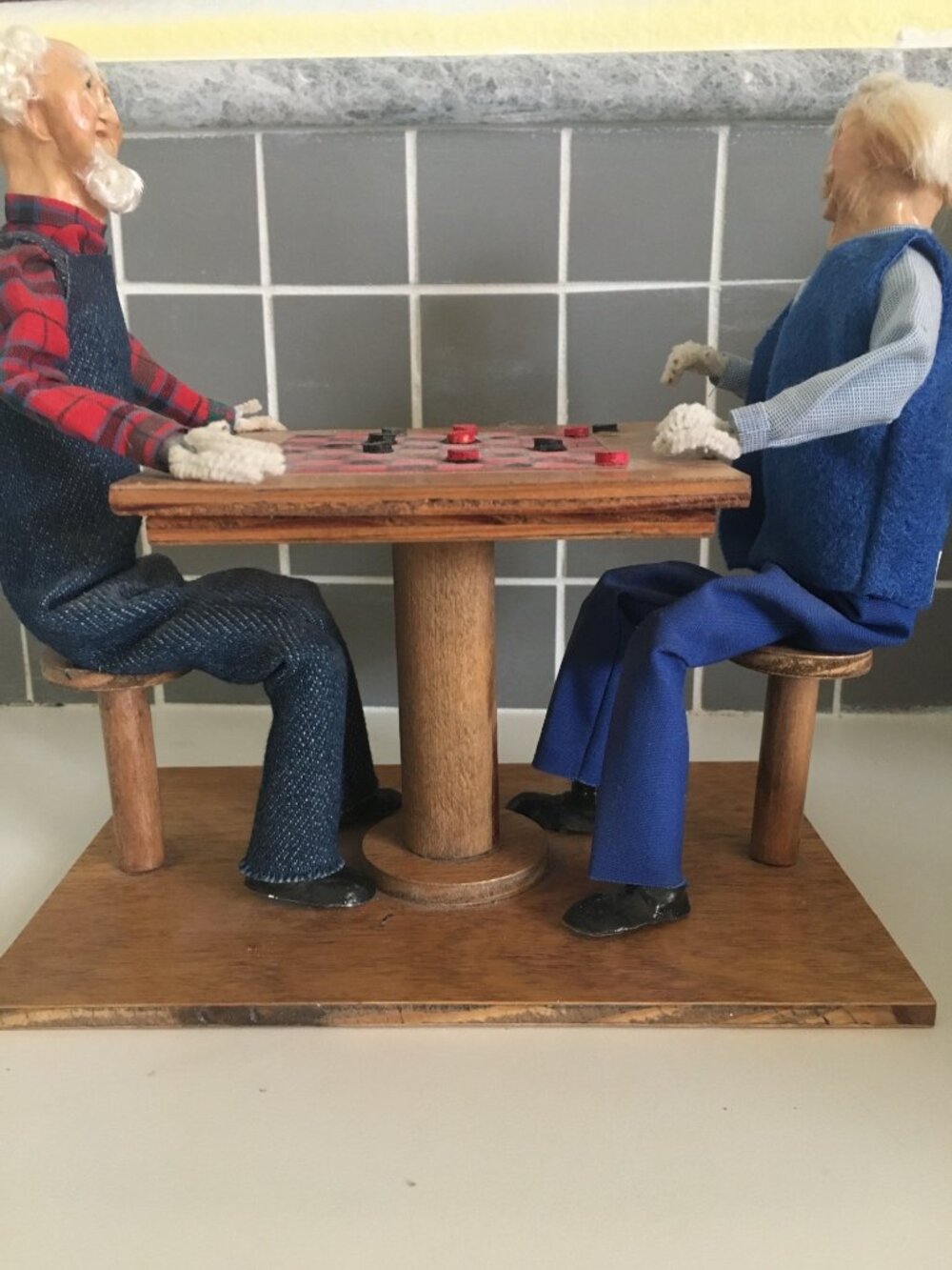 Vintage Handcrafted Wooden Checkerboard Scene With Two Elderly Figurines In Blue